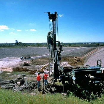 People operating a drill rig.